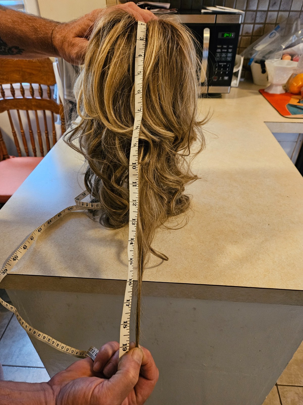 Blonde with brown lowlights, wavy wig. Size average ( trending towards large )