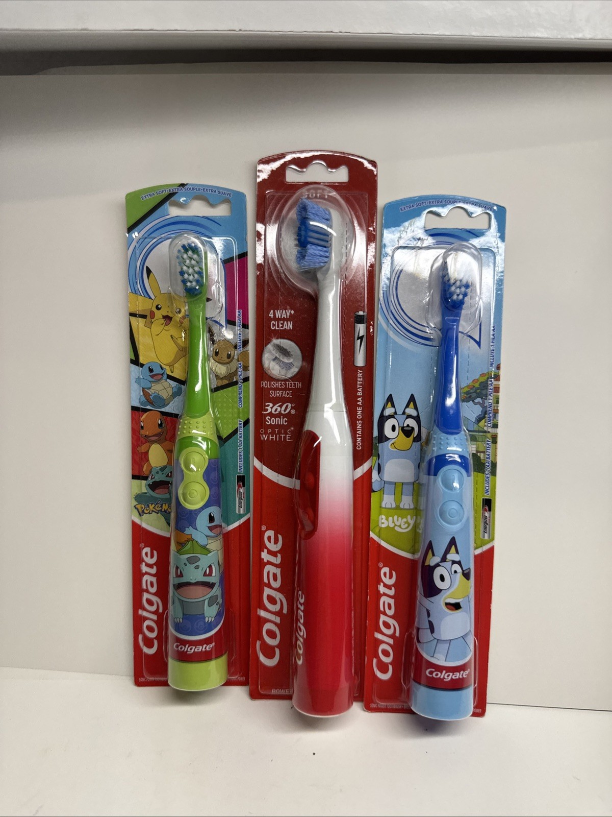 Colgate Battery Powered Toothbrush (3) Adult Optic White, Kids Pokémon & Bluey